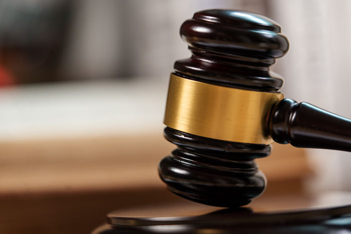 A gavel on a wooden surface, representing legal implications when men walked out after having a baby.