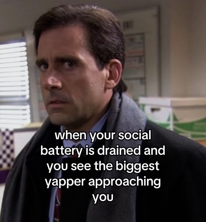 A relatable meme of Michael Scott looking annoyed, representing drained social battery and an approaching yapper.