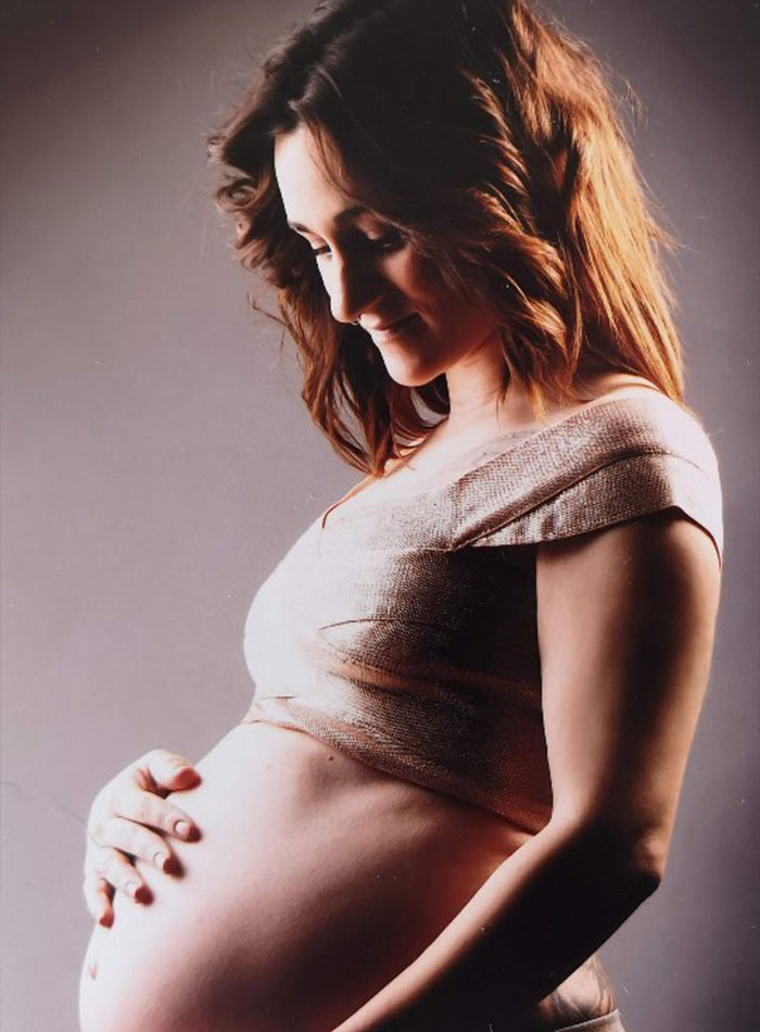 Pregnant woman cradles her baby bump, highlighting the half-siblings' decision to have children together despite controversy. Pregnant woman cradles her baby bump, highlighting the half-siblings' decision to have children together despite controversy.