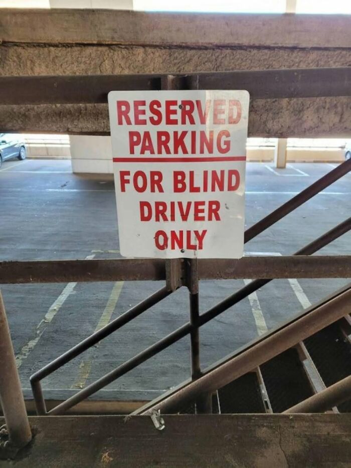 A ridiculous post showing a parking sign that says RESERVED PARKING FOR BLIND DRIVER ONLY, highlighting cultural decline.