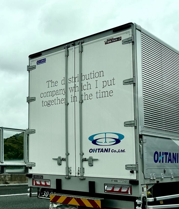 The back of a delivery truck in Japan with text that reads 'The distribution company which I put together in the time,' an example of getting lost in translation.
