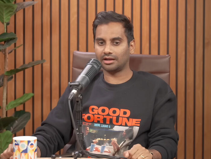 Aziz Ansari speaking into a microphone, discussing his lifestyle and marriage. Aziz Ansari speaking into a microphone, discussing his lifestyle and marriage.