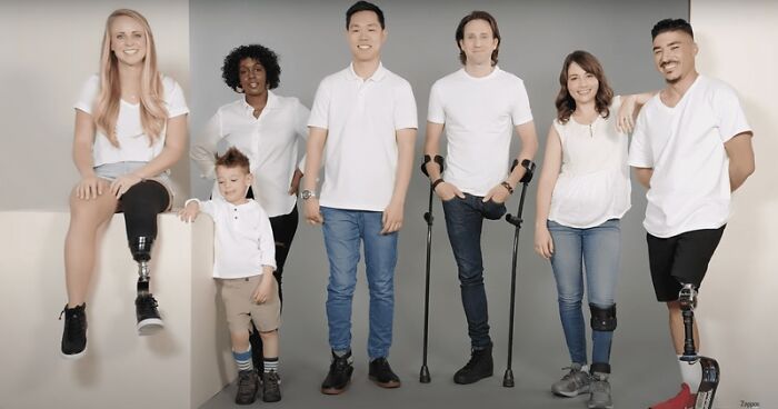 A group of people, some with prosthetic limbs, posing against a gray background, highlighting genius ideas.