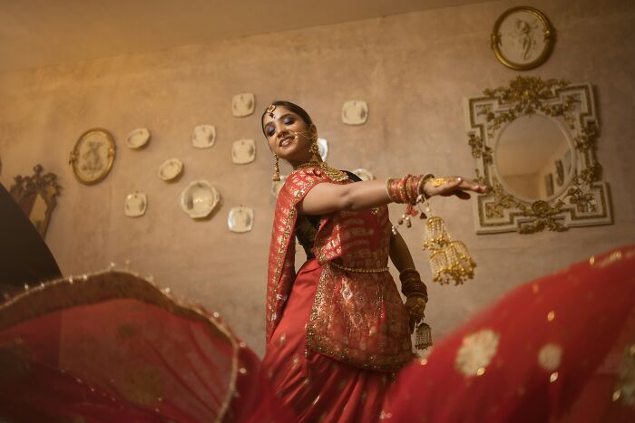 A woman in traditional Indian attire dances gracefully, showcasing cultural heritage. Stories of people got fired from jobs.
