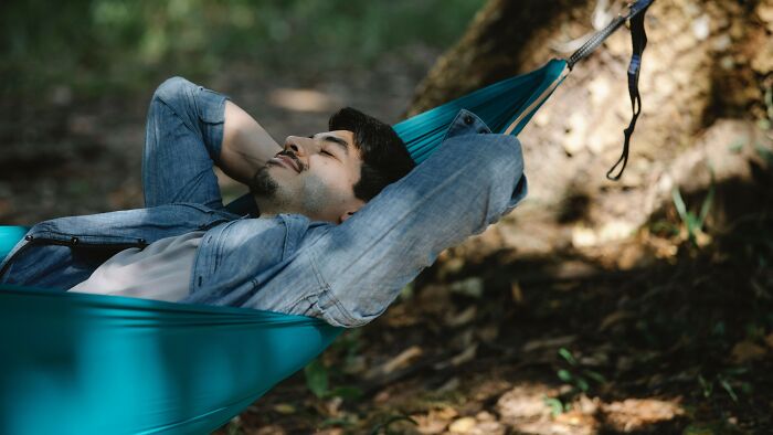 A man relaxing in a hammock, enjoying the outdoors. Learn more about family pictures and relationship dilemmas.