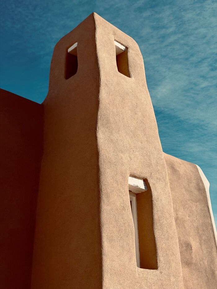 An adobe building tower against a blue sky, an extraordinary winning photo from the iPhone Photography Awards.