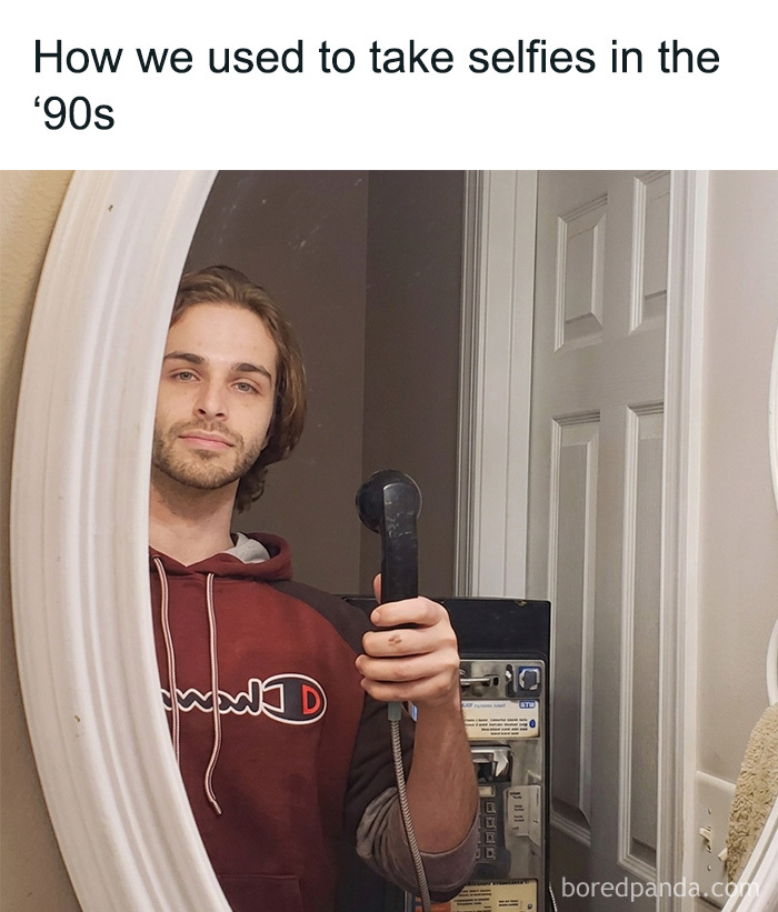 A man takes a mirror selfie with an old corded telephone, a throwback meme for 90s kids.