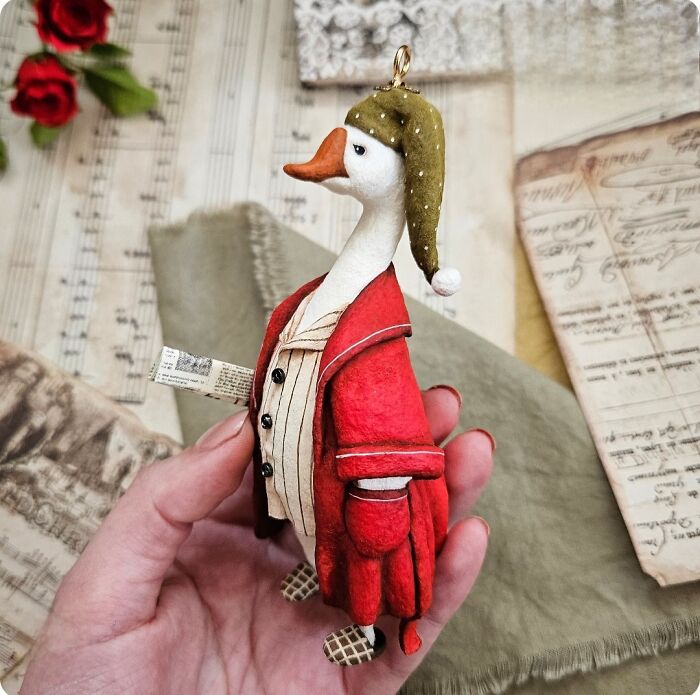 Whimsical handmade cotton wool goose in a red robe and nightcap, a unique creation.