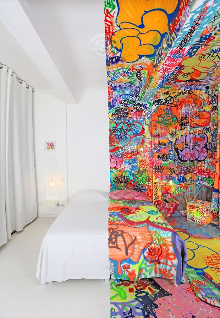 A split image of a room; one side is plain white, the other covered in colorful graffiti, making your brain question if it was edited.