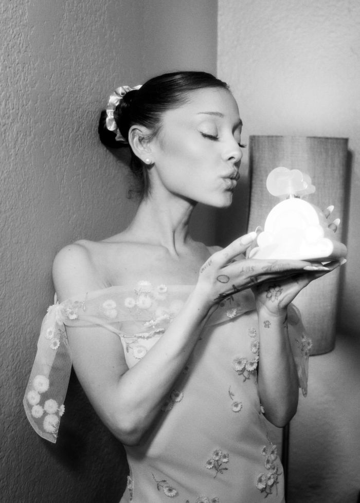 A black and white image of a woman with her eyes closed, holding a small object, showing a body type men really want. A black and white image of a woman with her eyes closed, holding a small object, showing a body type men really want.