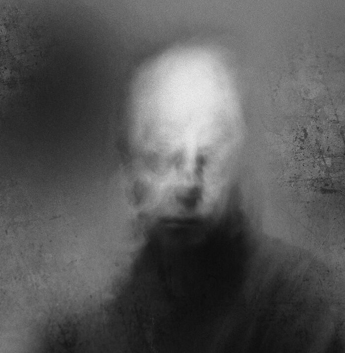 Abstract black and white photograph of a blurred, ethereal face, conveying deep emotion.