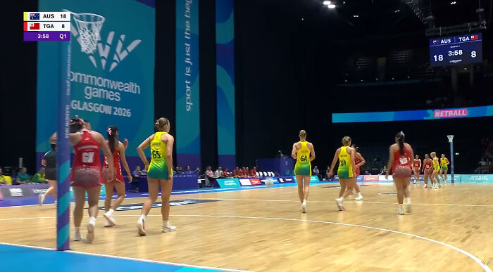 Female athletes on the netball court during a match, featuring a wardrobe malfunction.