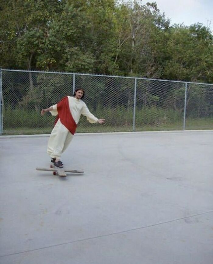 A man dressed as Jesus on a skateboard, creating a confusing image that needs a priest.