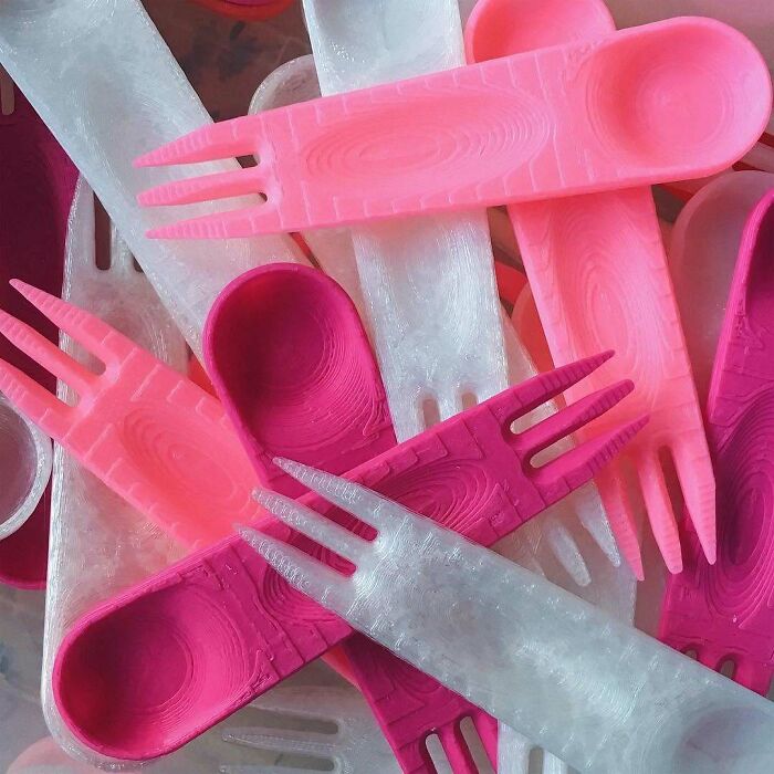 A pile of pink and white 3D printing creations of sporks. Amazing 3D printing creations.