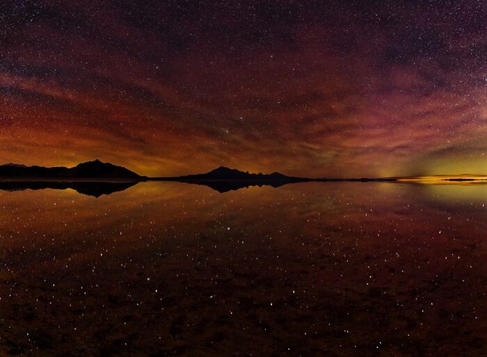 Remarkable color photo of a starry night sky reflecting over still water, capturing the world's beauty.