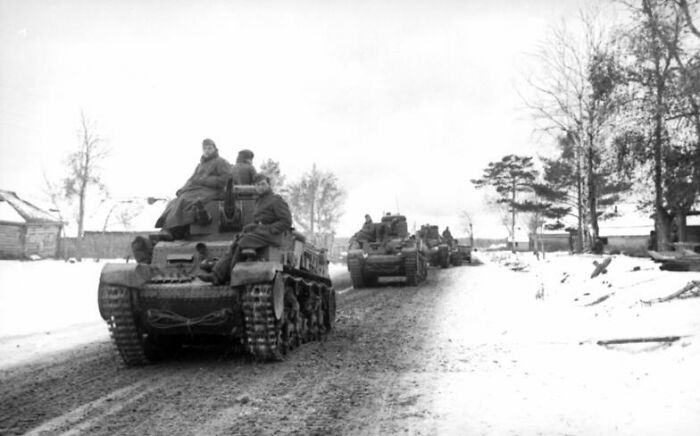 A line of military tanks moving along a snowy, muddy road, representing historical myths.