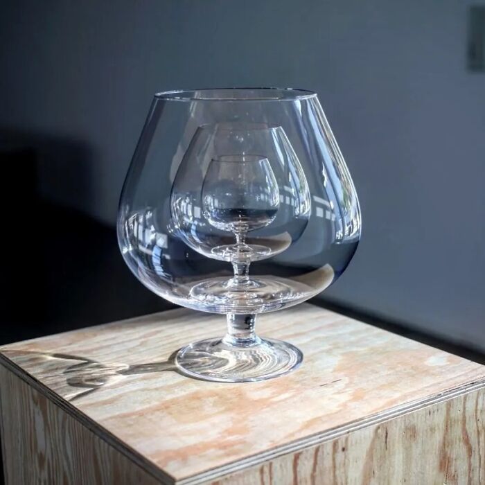 A brilliant design choice: three clear brandy glasses nested inside each other, showcasing clever visual design.