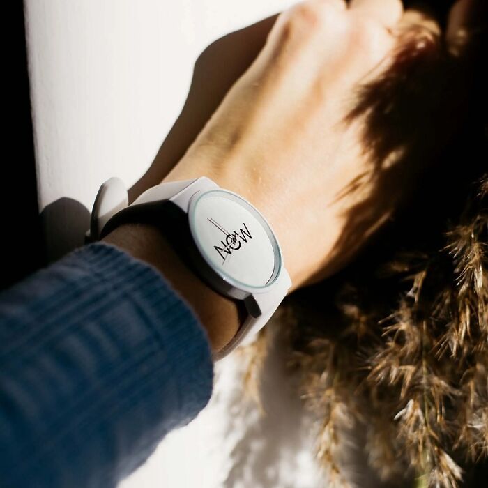 A brilliant design choice: a minimalist watch with 'NOW' written on its face, representing a unique concept.