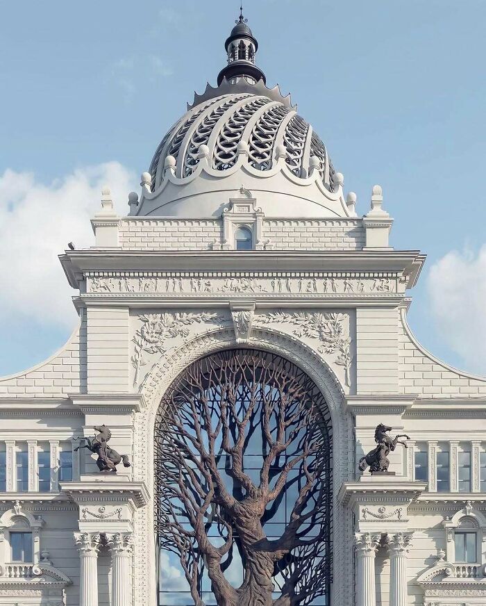 A brilliant design choice for a grand white building featuring a large ornate dome and a tree-like archway.