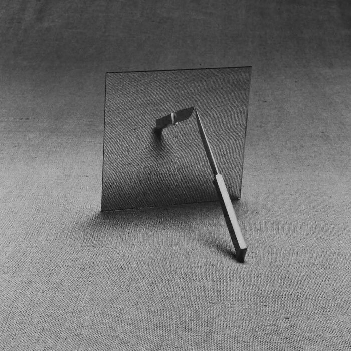 Brilliant design choices: A black and white photo of a metal object embedded in a translucent, textured sheet.