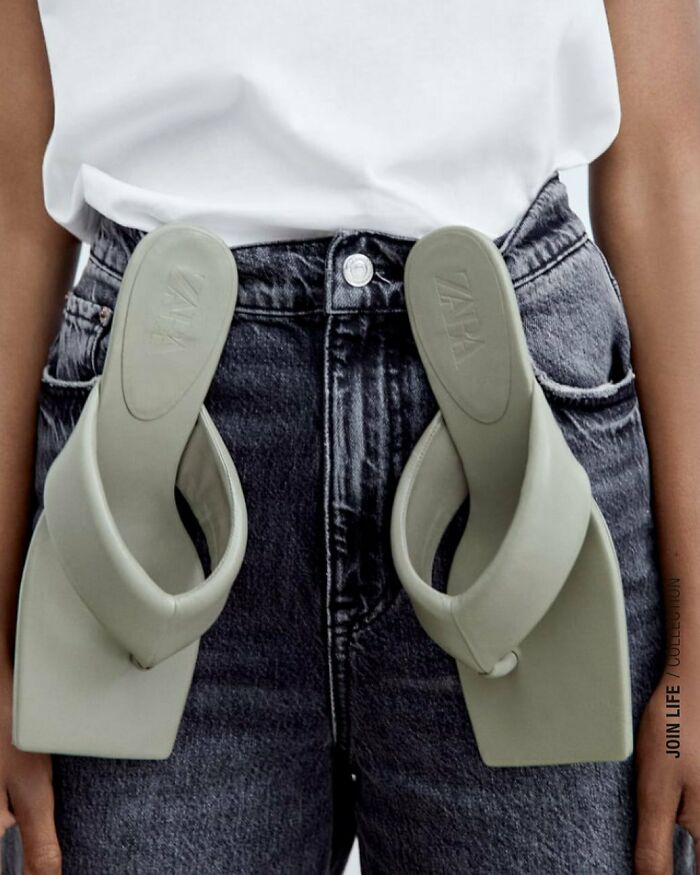 A person with Zara website bizarre content showing sandals tucked into their jeans waistband.