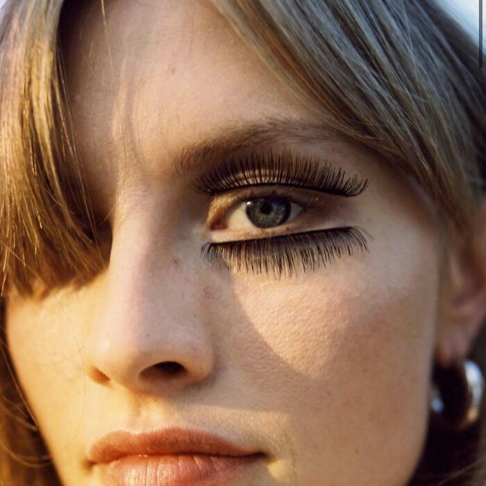 A close-up of an eye with exaggerated, bizarre eyelashes, from the Zara website content.