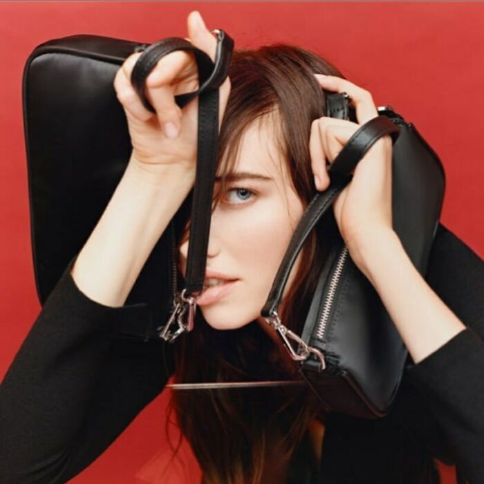 A woman with two black bags around her face, reflecting the bizarre content on Zara website.