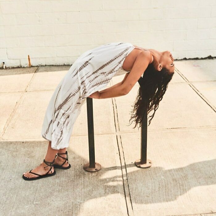 A woman bending backwards over two poles, displaying bizarre content on the Zara website.