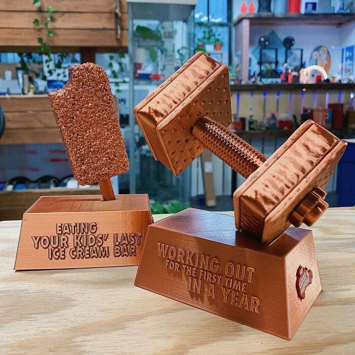 Amazing 3D printing creations: humorous trophies for eating kids last ice cream and working out for the first time.
