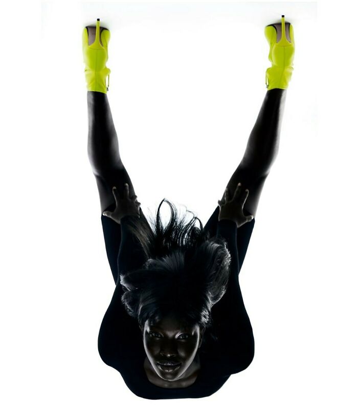 An upside-down model in neon yellow shoes, part of the bizarre content on the Zara website.