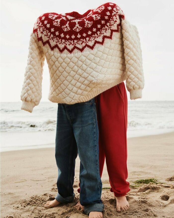 Bizarre content on Zara website: a headless figure in a sweater and jeans on the beach.