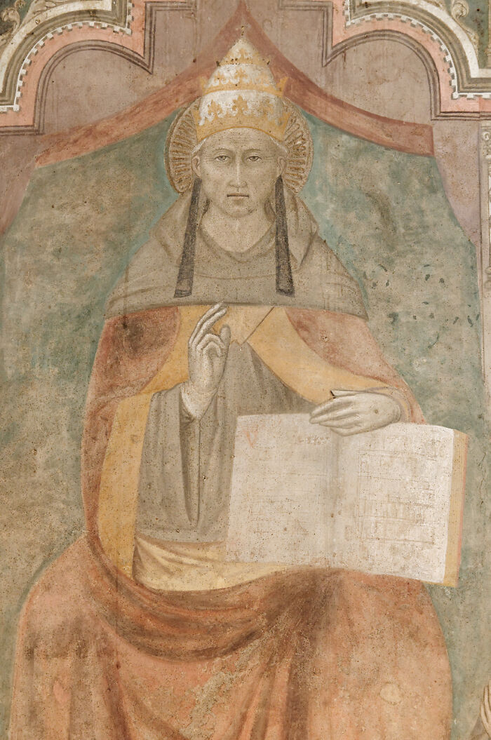 An old painting depicting a robed figure wearing a crown and holding an open book. Fascinating things about the world.