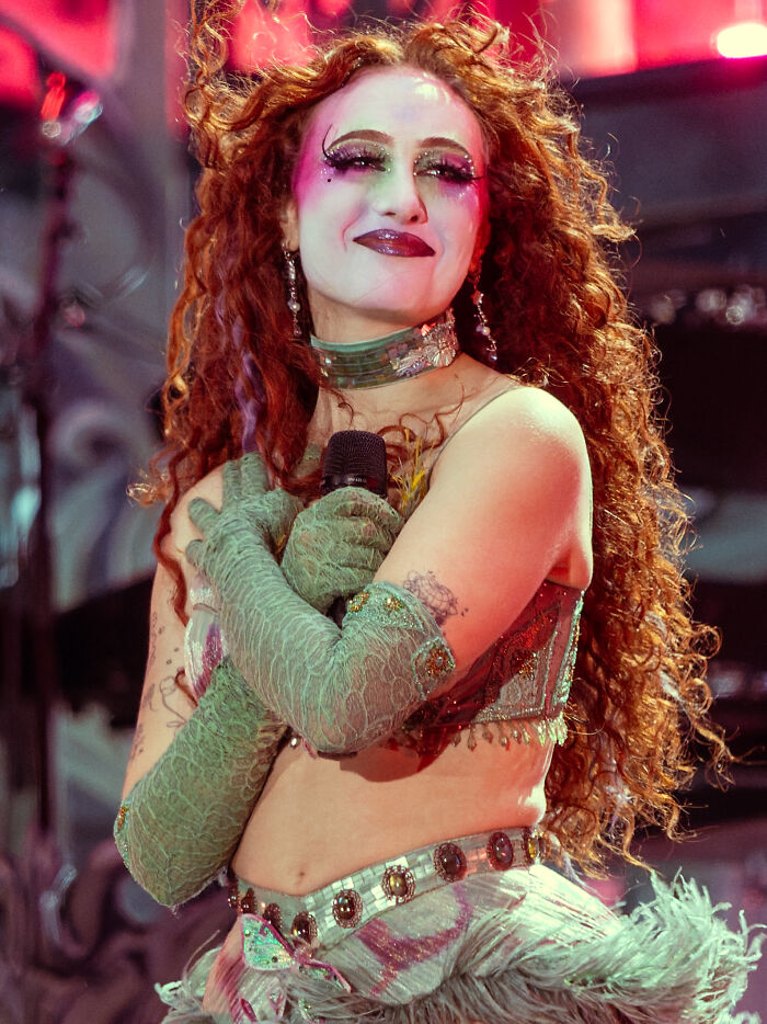 A female celebrity performing, her exaggerated makeup and outfit could disillusion fans. Disillusioned favorite celebrities.