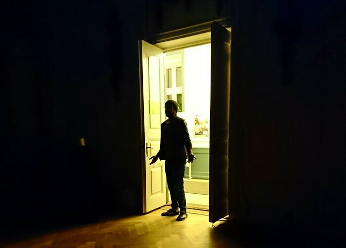 A man standing in a doorway, silhouetted against a bright room, symbolizing emerging with amazing comebacks.