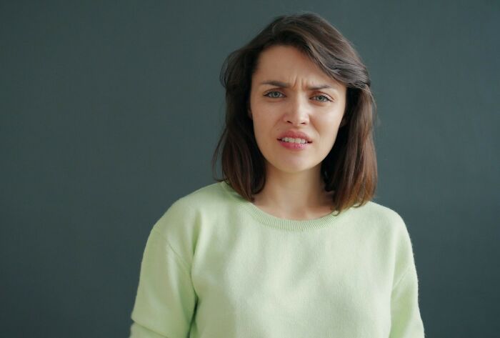 A woman with a confused expression on her face, possibly reacting to an insult, demonstrating amazing comebacks.
