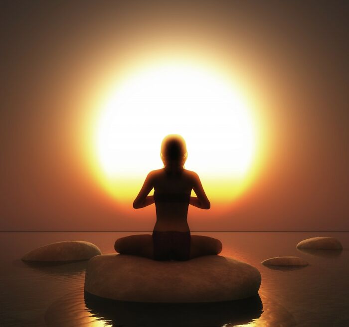 Silhouette of a woman meditating at sunset, finding an amazing comeback through peace. Turning insults into art.