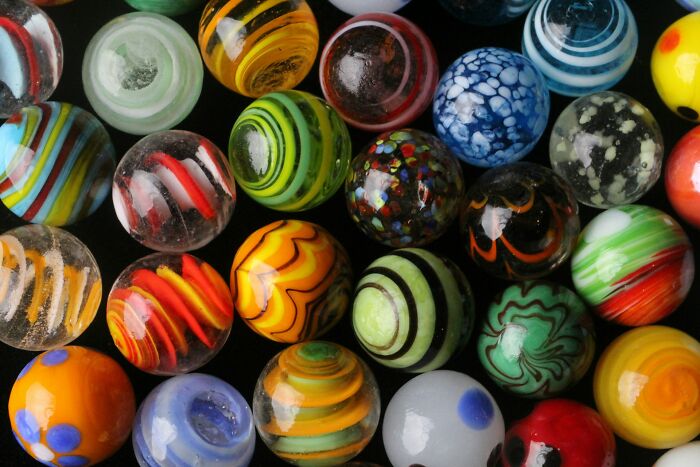 Collection of colorful glass marbles, symbolizing amazing comebacks and turning insults into art with vibrant patterns.