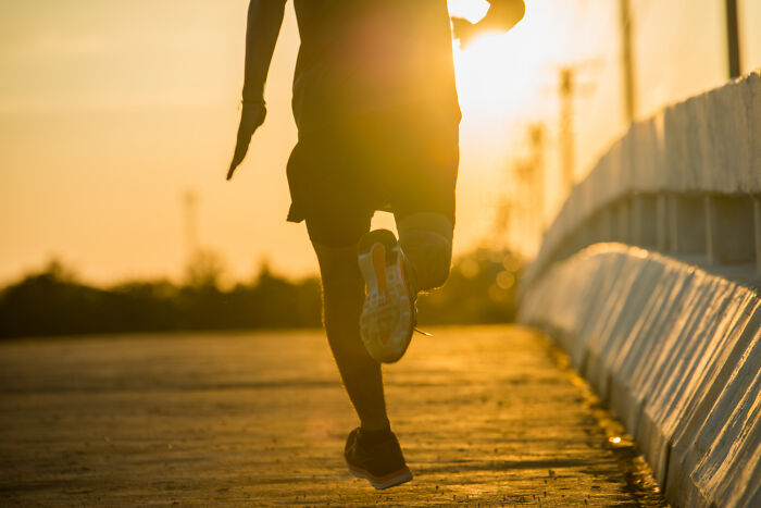 A runner at sunset, moving with purpose. This image captures the essence of amazing comebacks.