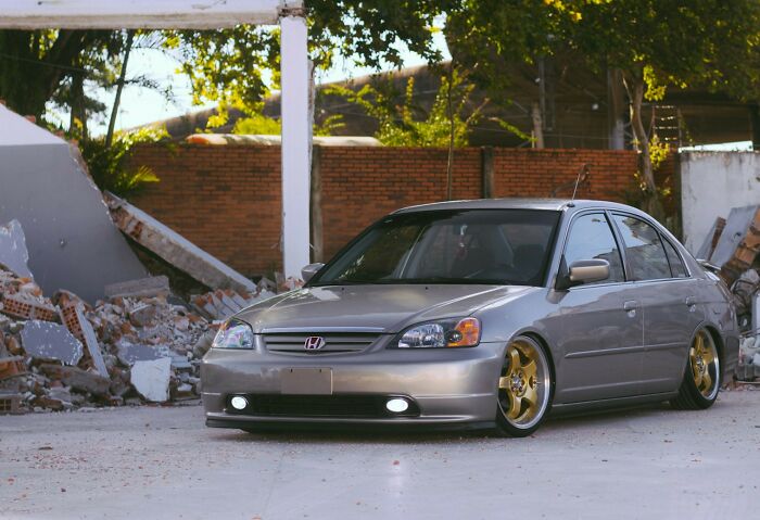 A custom car parked in a damaged area, symbolizing a strong comeback from adversity.