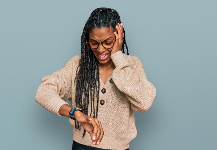 A woman looking stressed and checking her watch, an expression often seen before amazing comebacks.