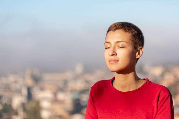 A person with short hair and closed eyes, seemingly in a moment of calm, perhaps before delivering an amazing comeback.