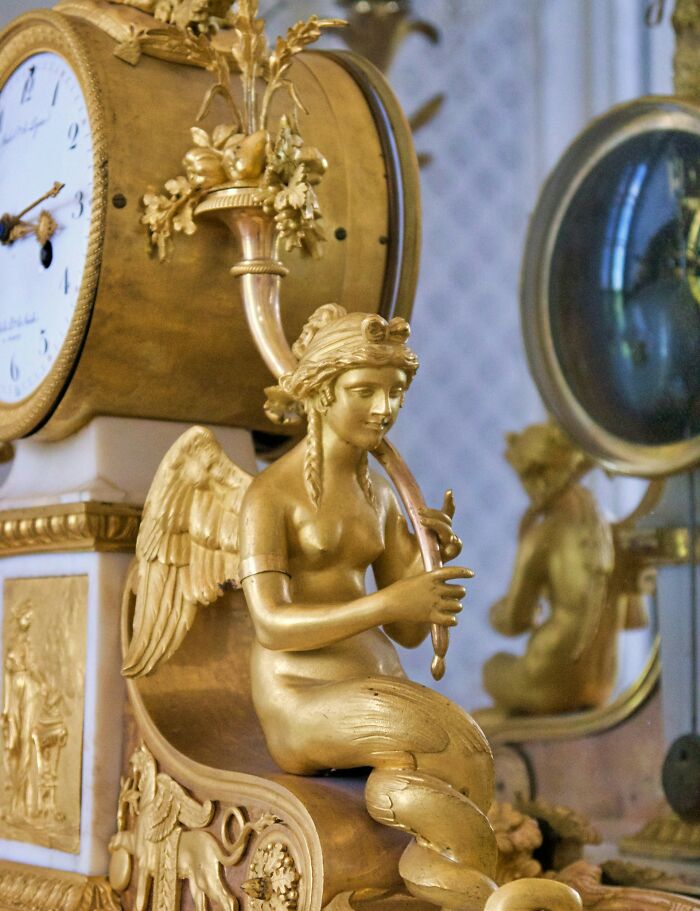 An ornate golden clock with a winged figure, evoking unsettling childhood memories that still give people chills.