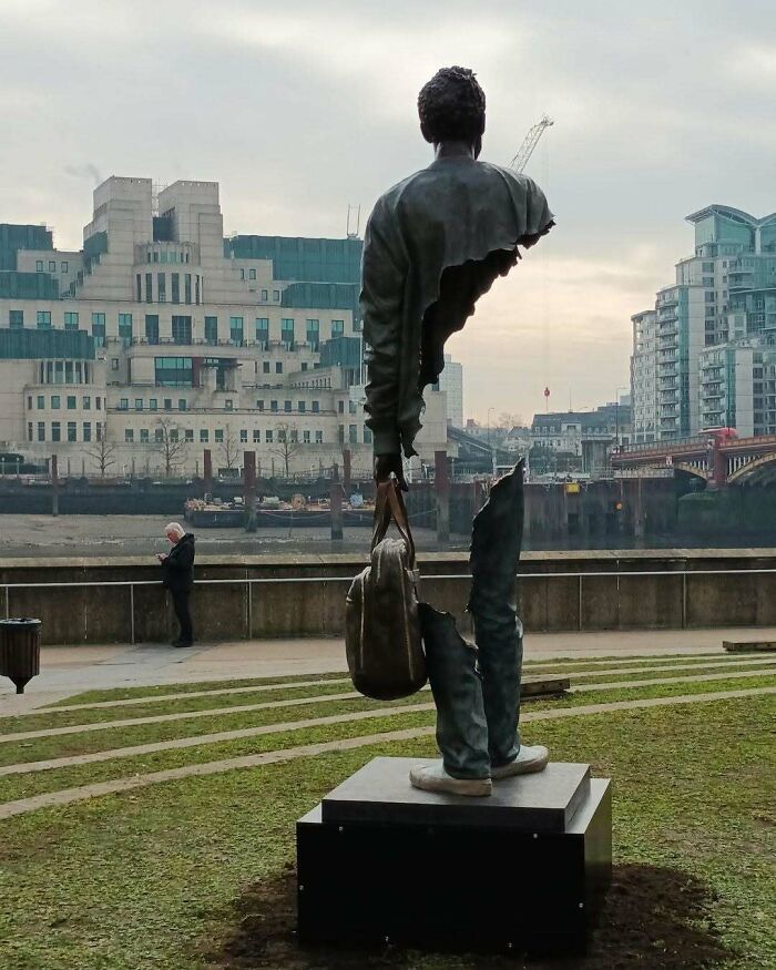 A broken, fragmented statue of a man standing with a bag, showcasing brilliant design.