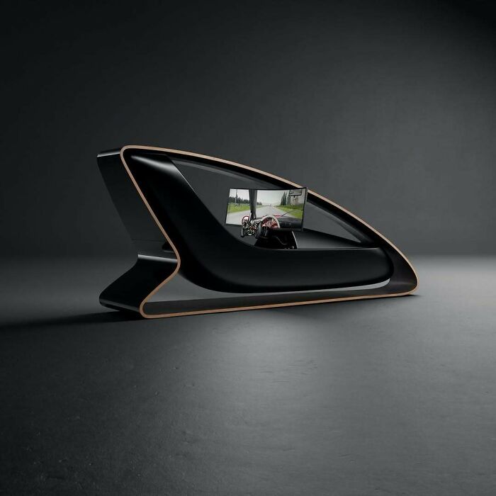 A brilliant design choice of a futuristic racing simulator, with a sleek black and wood frame.