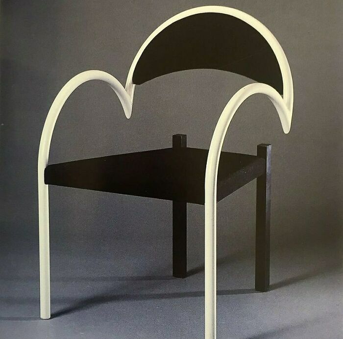 A striking black and white chair with a curved back and seat, highlighting brilliant design choices in modern furniture.