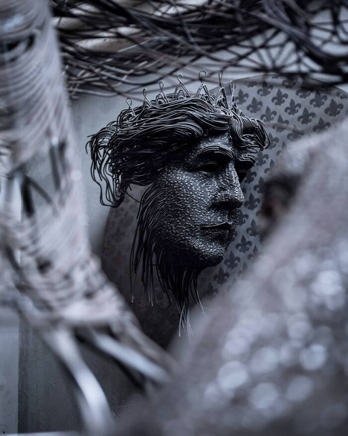 An intricate sculpture of a face made from interwoven wire, a brilliant design choice in art.