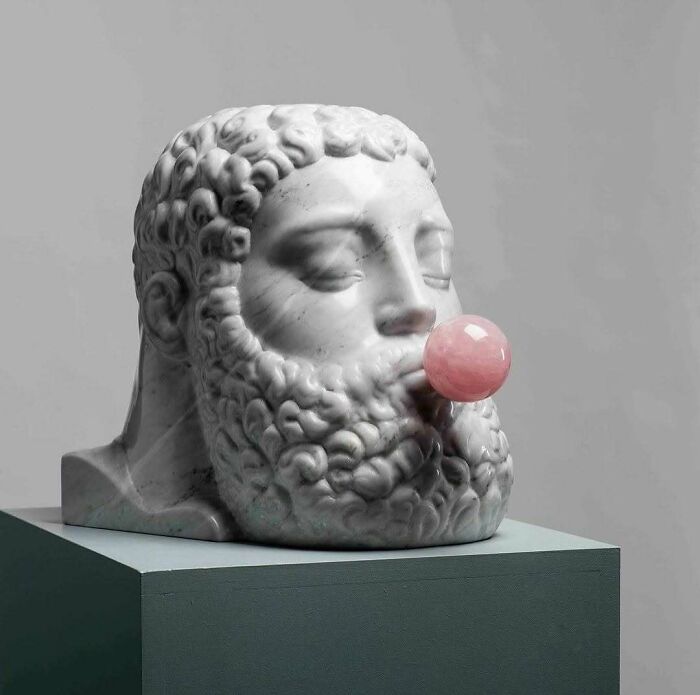 A brilliant design choice: a marble bust blowing a pink bubble gum bubble, adding a playful touch to a classic sculpture.
