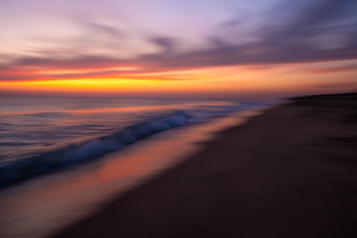 Award-winning photographer captures the beauty of nature through extraordinary close-up portraits of a blurred sunset over the ocean.
