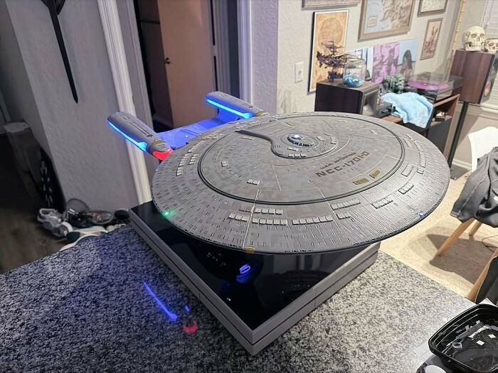 A magnificent USS Enterprise model, a shining example of 3D printing creations, gleaming with its intricate lights.