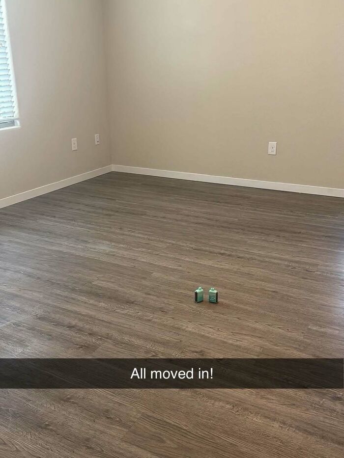 A minimalist living room with two small green bottles on a wooden floor, representing unhinged and cringe memes.
